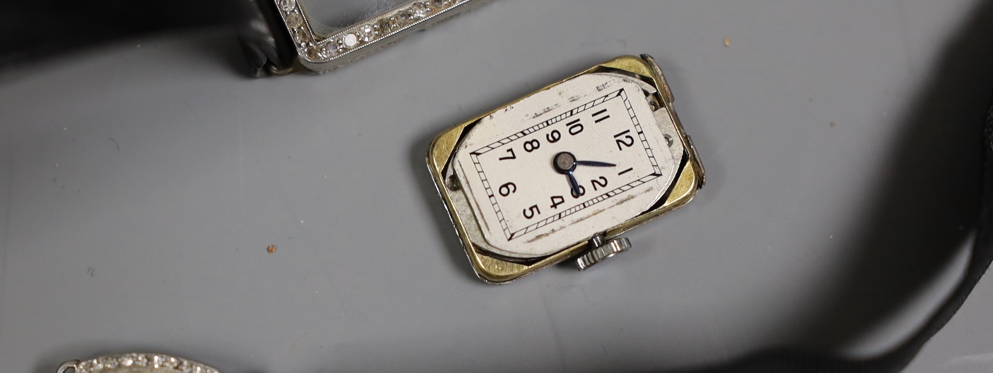 Three assorted mid 20th century white metal and diamond set manual wind cocktail watches, one stamped platinum, (a.f.).